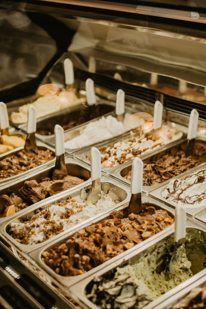 A vibrant display of various ice cream flavors in a shop setting, perfect for dessert lovers.